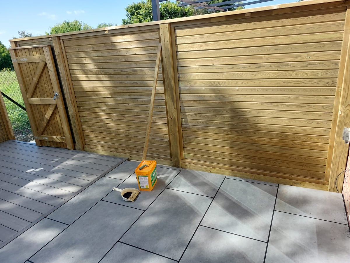 Finished horizontal timber screen fencing beside a paved patio