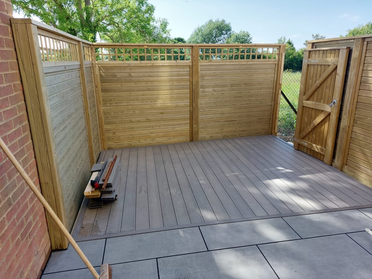 Finished timber screen fencing and gate around a decked garden area