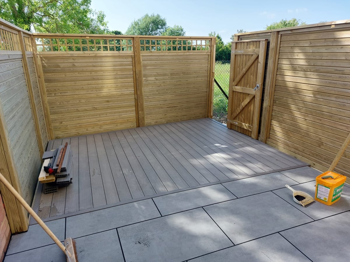 Finished timber screen fencing with gate and decked seating area