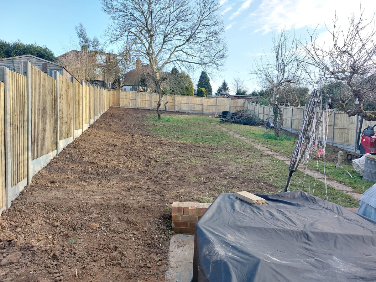 Long garden with new fence panels installed along both boundaries